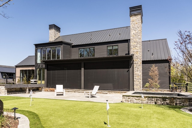 rear view of property with a patio area and a sunroom