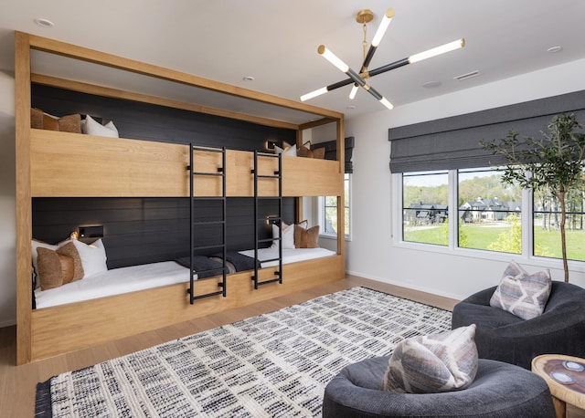 bedroom with hardwood / wood-style flooring and a chandelier