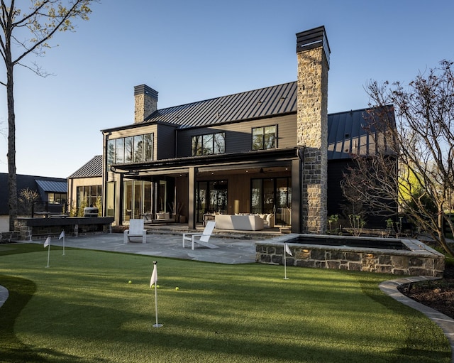 rear view of house featuring an outdoor living space and a patio