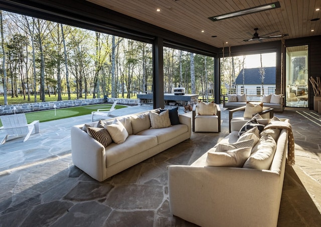 sunroom / solarium with wooden ceiling, a pool, and ceiling fan