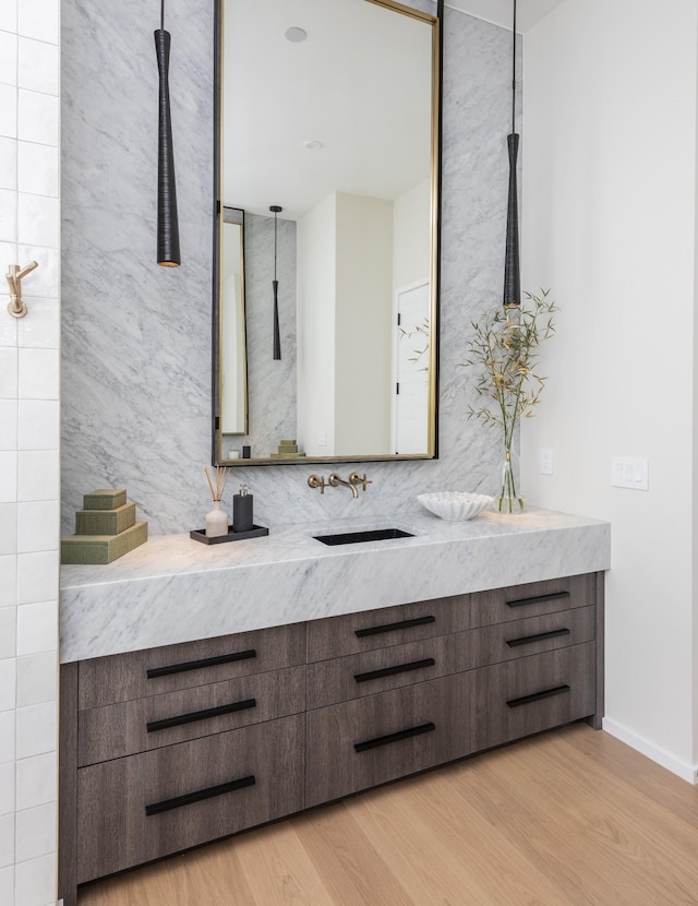 bathroom with vanity and hardwood / wood-style floors