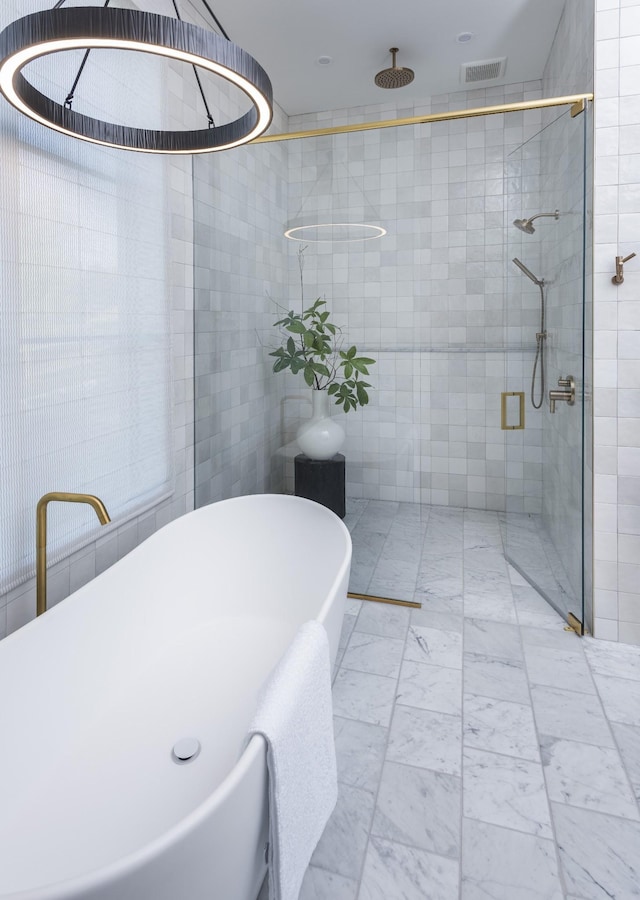 bathroom with independent shower and bath and tile walls