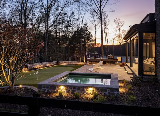 pool at dusk with a patio