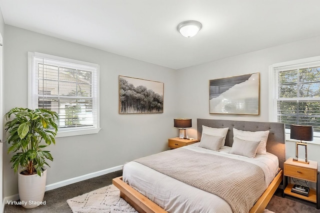 bedroom featuring dark colored carpet