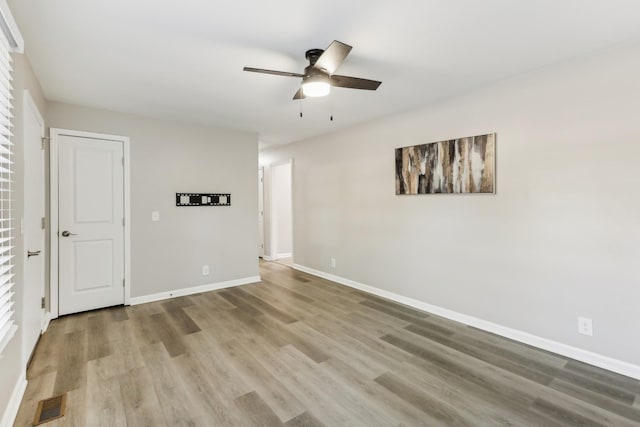 spare room with ceiling fan and hardwood / wood-style flooring