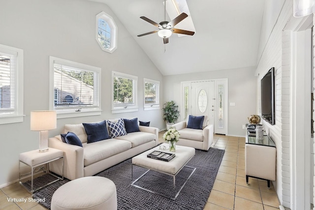 tiled living room with high vaulted ceiling and ceiling fan