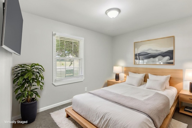 bedroom featuring dark colored carpet