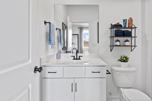 bathroom featuring toilet and vanity