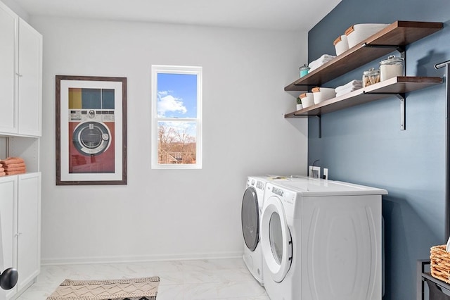 washroom with cabinets and washer and clothes dryer