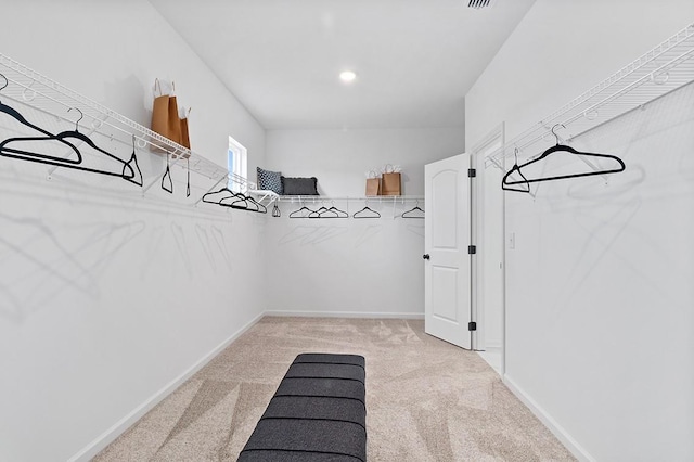 spacious closet featuring light carpet