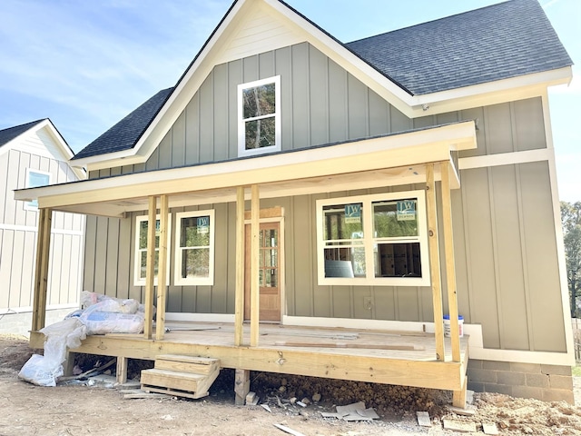 back of property with a porch