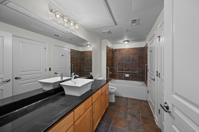 full bathroom featuring toilet, tiled shower / bath combo, and vanity