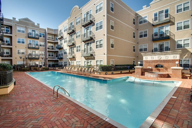 view of pool featuring pool water feature and central AC