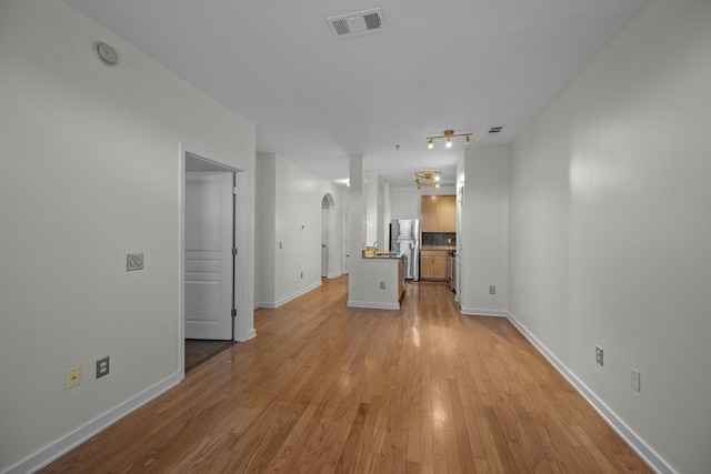 unfurnished living room with light hardwood / wood-style flooring