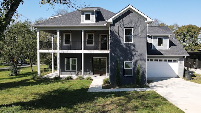 view of front of property featuring driveway, a balcony, an attached garage, covered porch, and a front yard