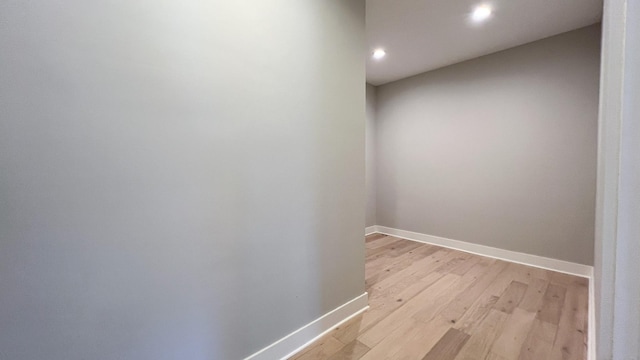 hall featuring baseboards and light wood-style floors