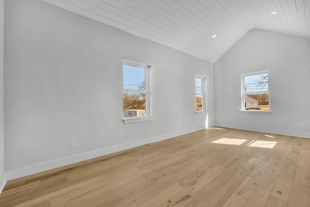 empty room with wooden ceiling, light wood-style floors, baseboards, and high vaulted ceiling