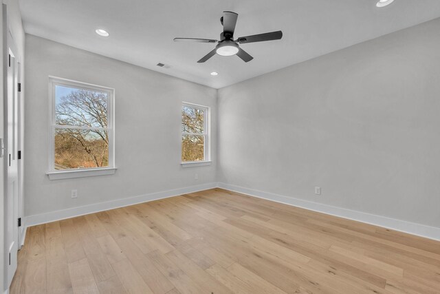 empty room with recessed lighting, light wood-type flooring, visible vents, and baseboards