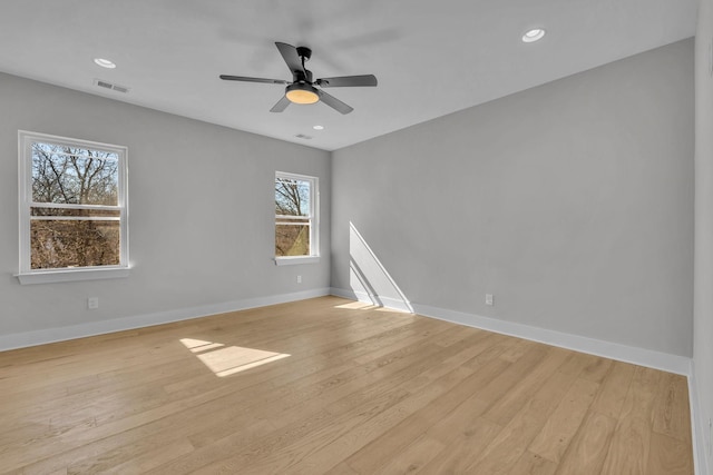 unfurnished room with recessed lighting, visible vents, light wood-style flooring, and baseboards