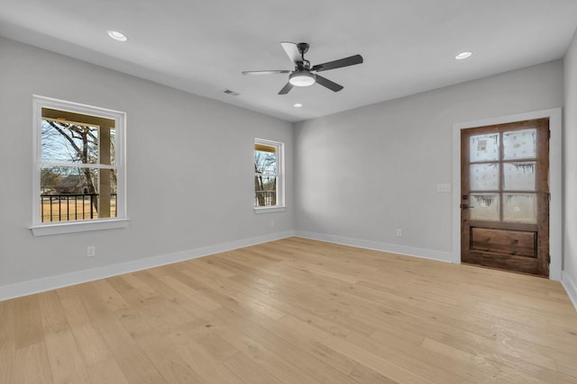 spare room with recessed lighting, light wood-type flooring, visible vents, and baseboards