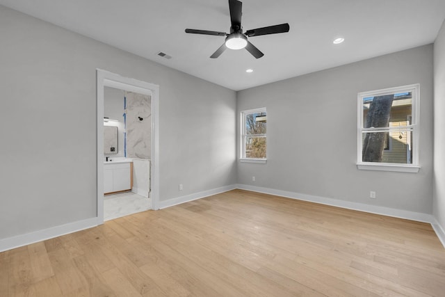 spare room featuring a ceiling fan, recessed lighting, light wood-style flooring, and baseboards