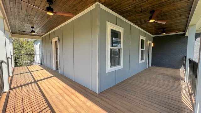 wooden deck featuring ceiling fan