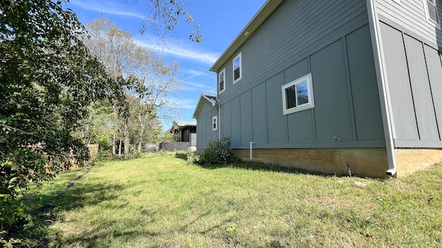 view of home's exterior featuring board and batten siding and a yard