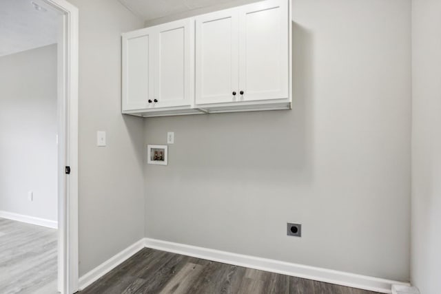 laundry area with cabinets, hookup for a washing machine, hookup for an electric dryer, and dark wood-type flooring