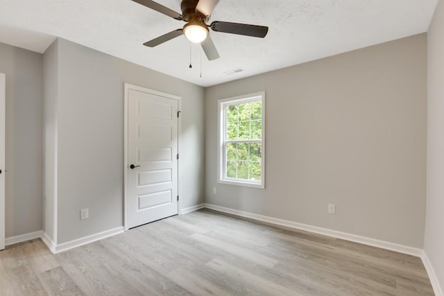 unfurnished room with ceiling fan and light hardwood / wood-style flooring