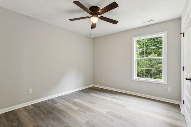 empty room featuring ceiling fan and light hardwood / wood-style floors