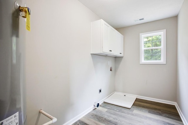 laundry area featuring light wood-type flooring, hookup for an electric dryer, and cabinets