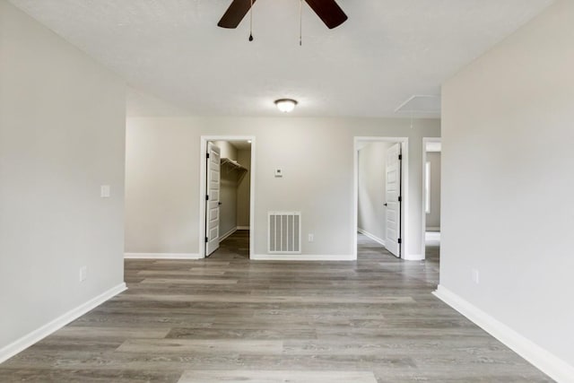 unfurnished room with ceiling fan and wood-type flooring