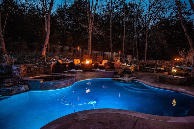 view of pool featuring an in ground hot tub and a fire pit