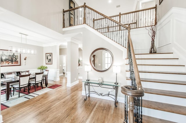 stairway featuring a high ceiling and wood-type flooring