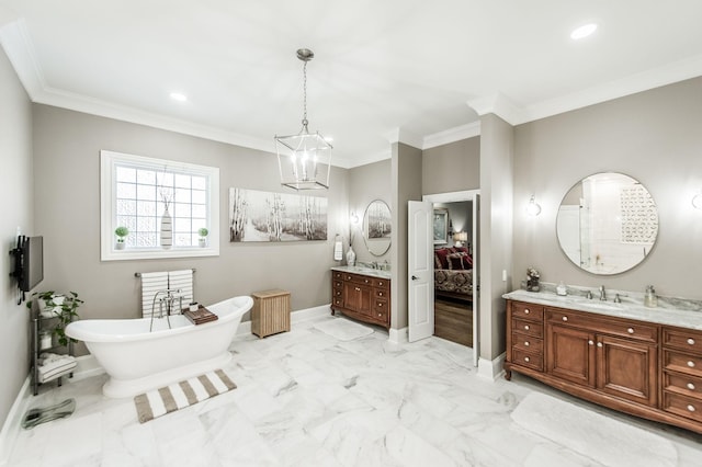 bathroom with ornamental molding, vanity, and a bathtub