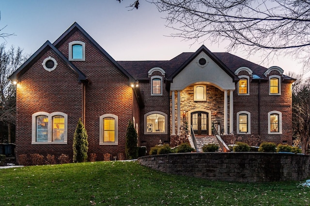 french provincial home featuring a lawn