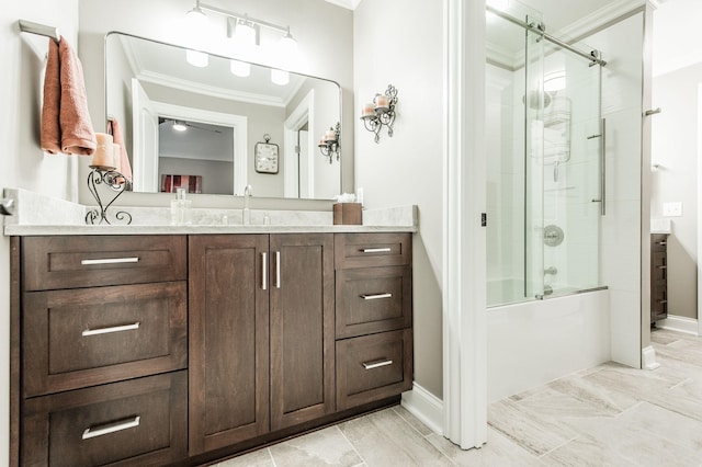 bathroom featuring ornamental molding, vanity, and bath / shower combo with glass door