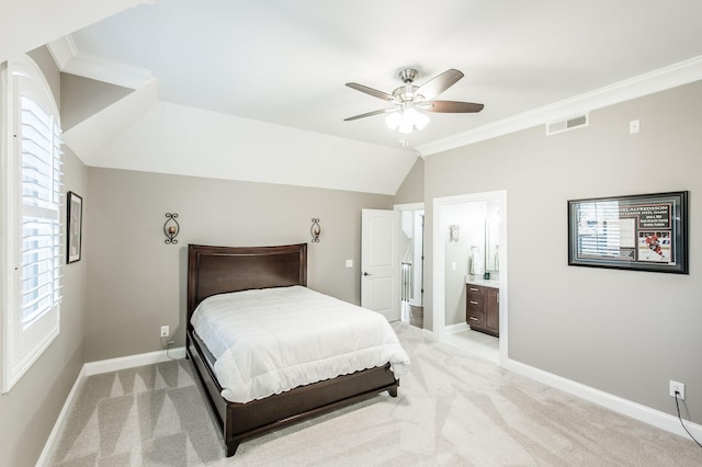 bedroom with ornamental molding, vaulted ceiling, and light colored carpet