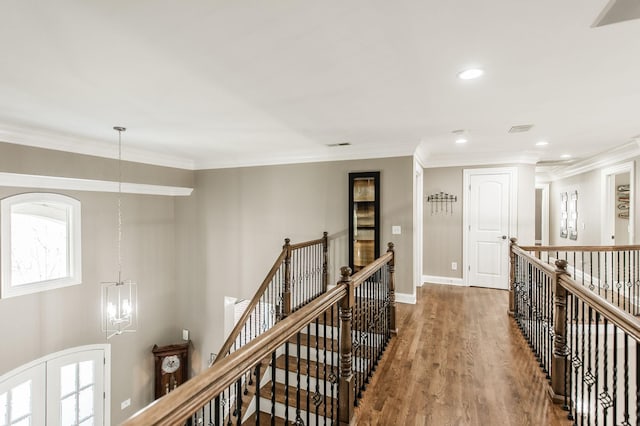 hall featuring crown molding, a chandelier, hardwood / wood-style floors, and french doors