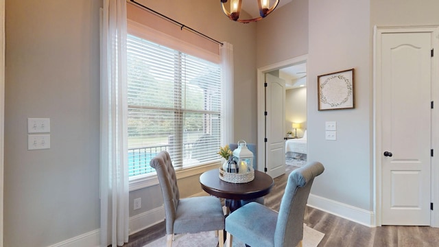 dining space with a healthy amount of sunlight, a chandelier, and hardwood / wood-style floors