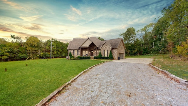 view of front of home featuring a garage and a lawn