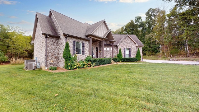 view of front of house featuring central AC unit and a front yard