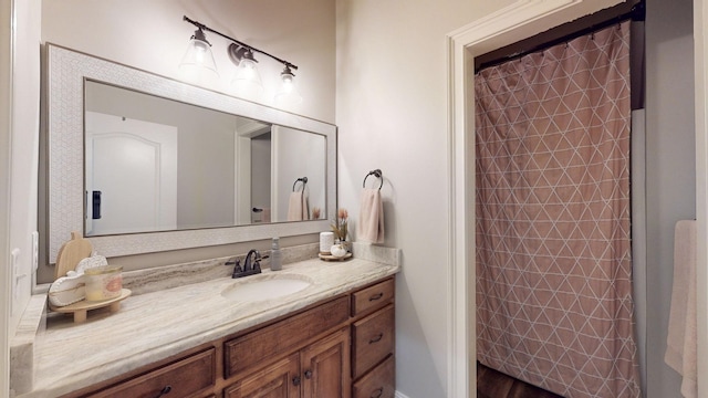 bathroom featuring vanity, a shower with shower curtain, and hardwood / wood-style floors