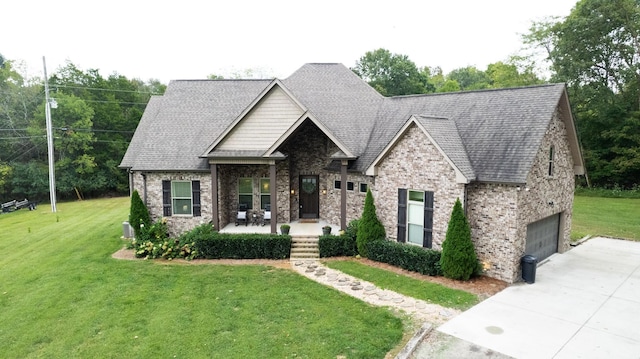 view of front of house with a front lawn, a garage, and a porch