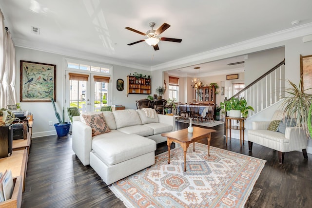 living room with ornamental molding, ceiling fan with notable chandelier, and dark hardwood / wood-style floors