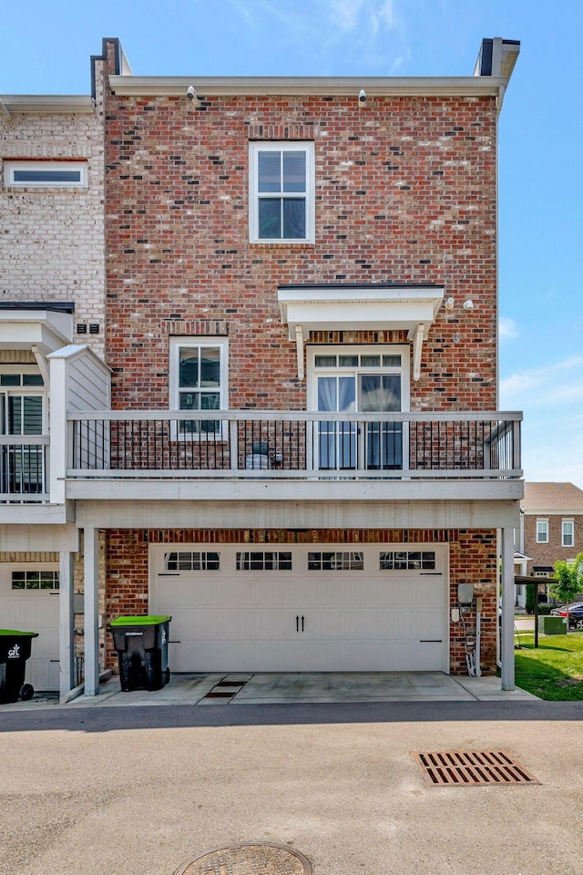 view of front of property with a garage and a balcony