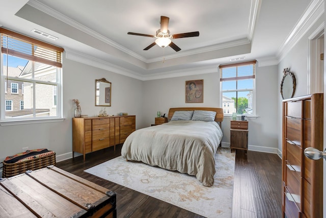 bedroom with a raised ceiling, ceiling fan, dark hardwood / wood-style floors, and crown molding