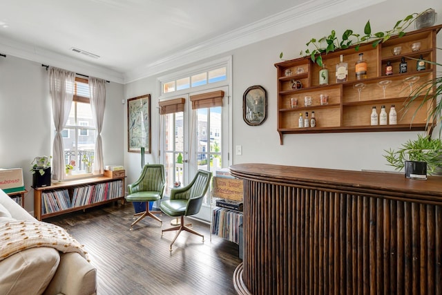 living area featuring dark wood-type flooring and ornamental molding