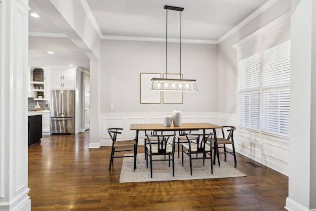 dining room featuring dark hardwood / wood-style flooring and ornamental molding