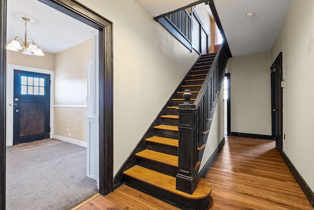 stairway featuring a chandelier and hardwood / wood-style flooring